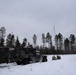 Soldiers set up an antenna to support artillery communication