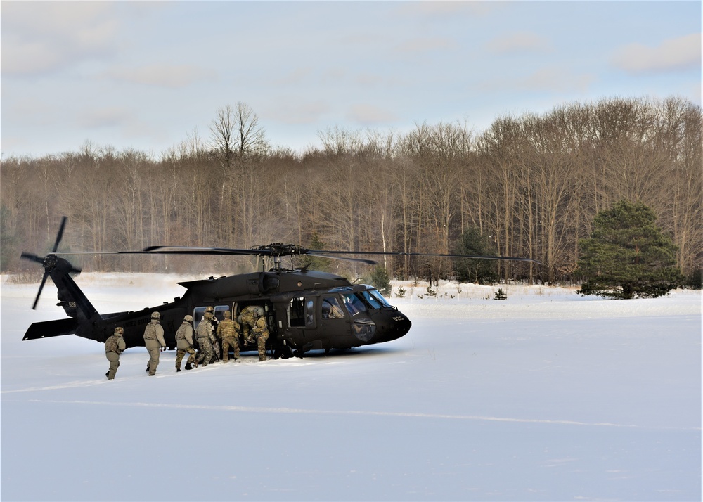 Soldiers receive an airlift home after a cold day