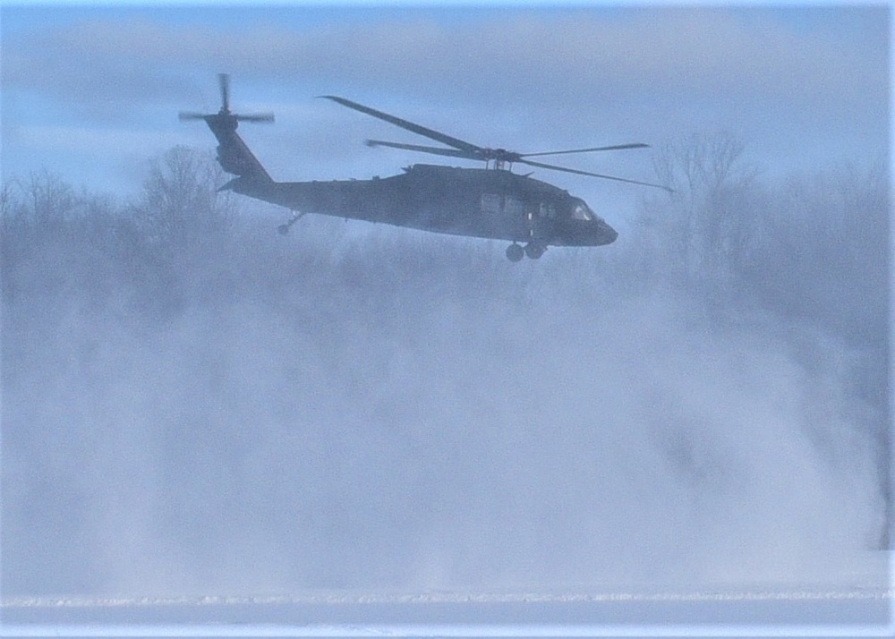 Helicopter blades stir up snow during cold weather training