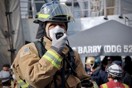 Sailors and Firefighters from USS Barry, USS Howard and CFAY Emergency Services Conduct Integrated Fire Drill