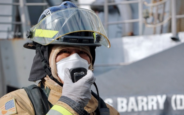 Sailors and Firefighters from USS Barry, USS Howard and CFAY Emergency Services Conduct Integrated Fire Drill