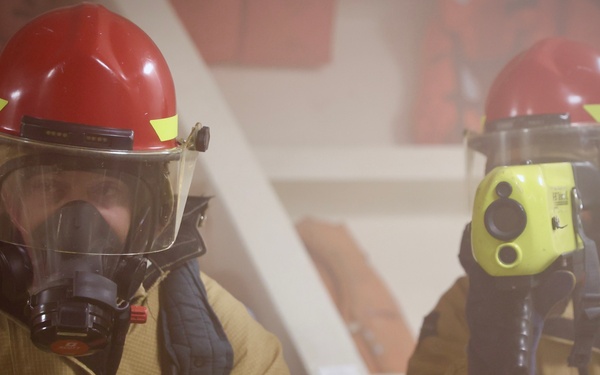 Sailors and Firefighters from USS Barry, USS Howard and CFAY Emergency Services Conduct Integrated Fire Drill