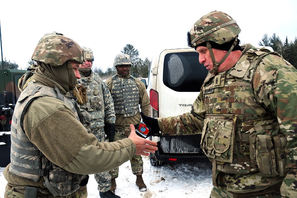 Command Sgt. Maj. Patrouille Presents His Challenge Coin to Wisconsin Soldiers