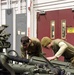 Michigan and Wisconsin National Guard Soldiers maintain howitzer at MATES during Winter Strike