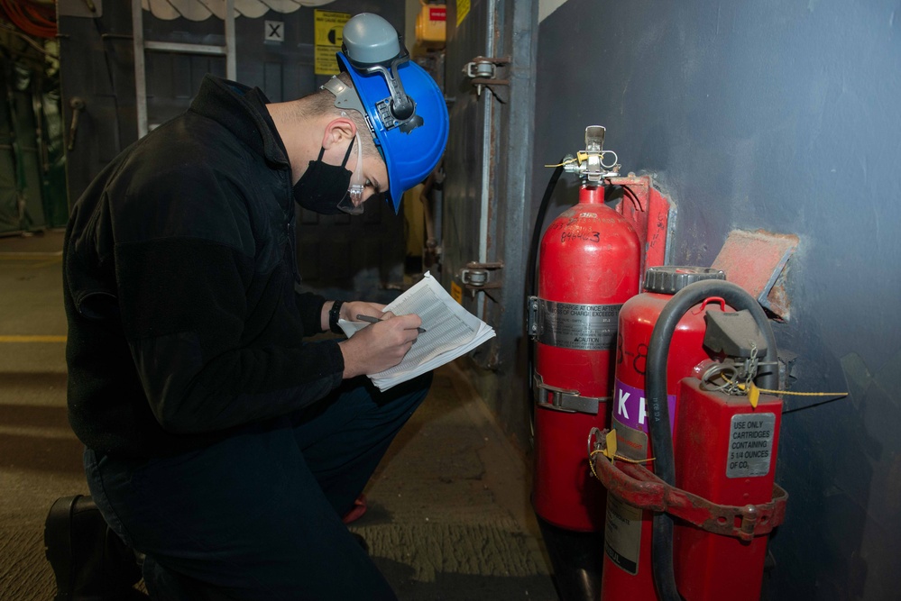 Sailor inspects fire extinguisher