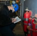 Sailor inspects fire extinguisher