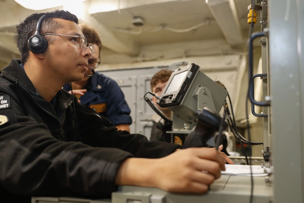 Abraham Lincoln Sailors operate a CIWS