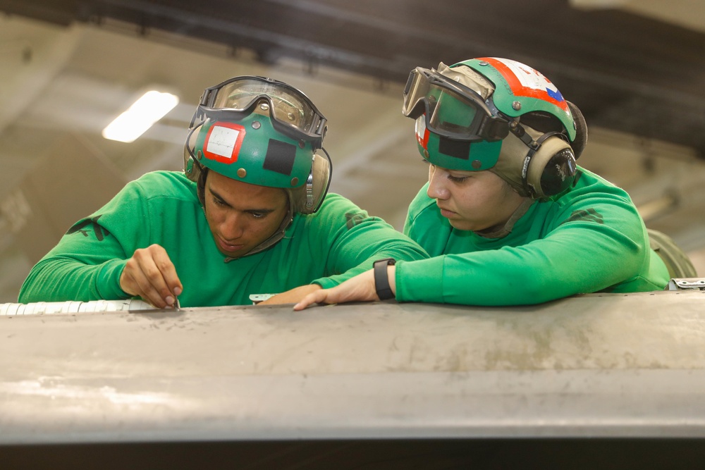 Abraham Lincoln Sailors conduct aircraft maintenance