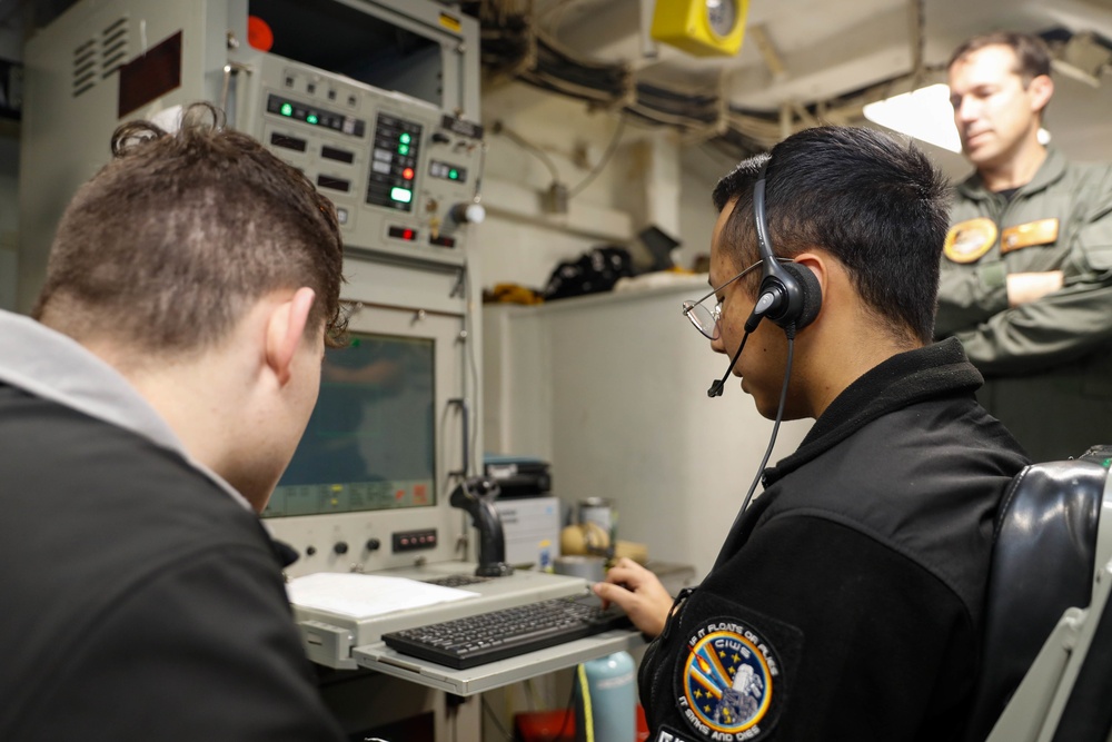 Abraham Lincoln Sailors operate a CIWS