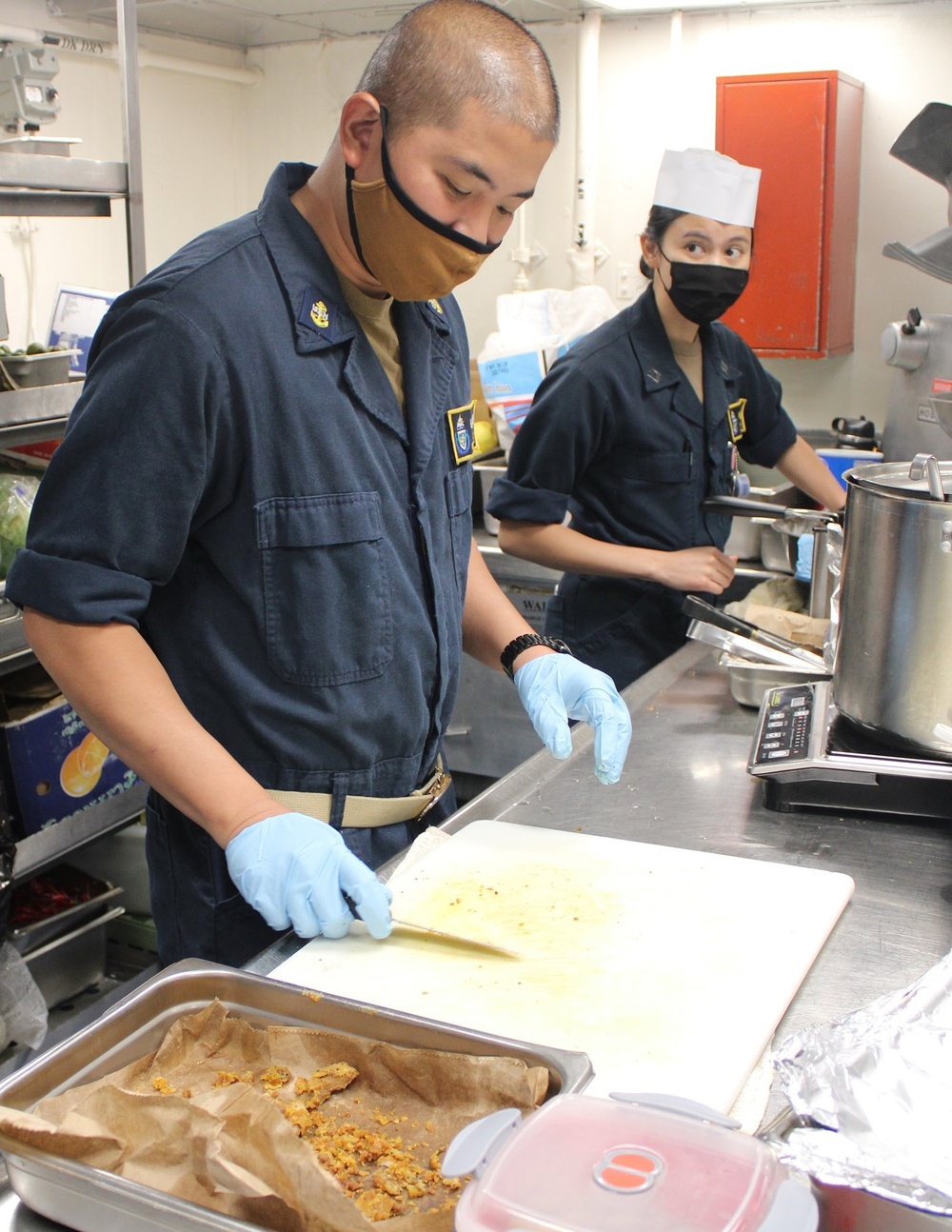 USS Lake Champlain (CG 57) Sailors Prepares Dinner