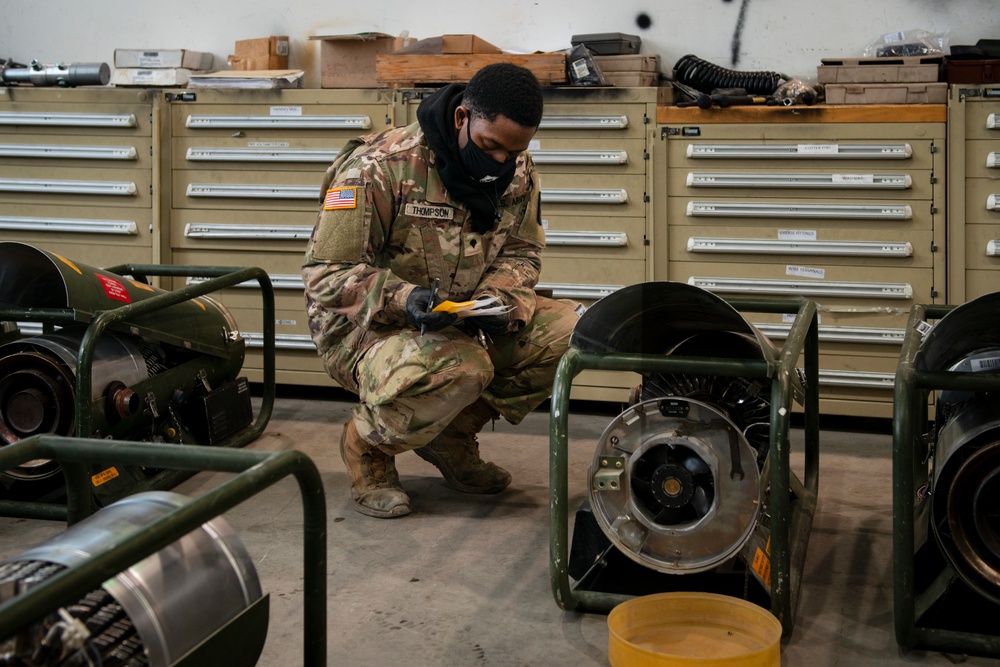 A Soldier dismantles and repairs an HDT SHC35 “bullet heater."