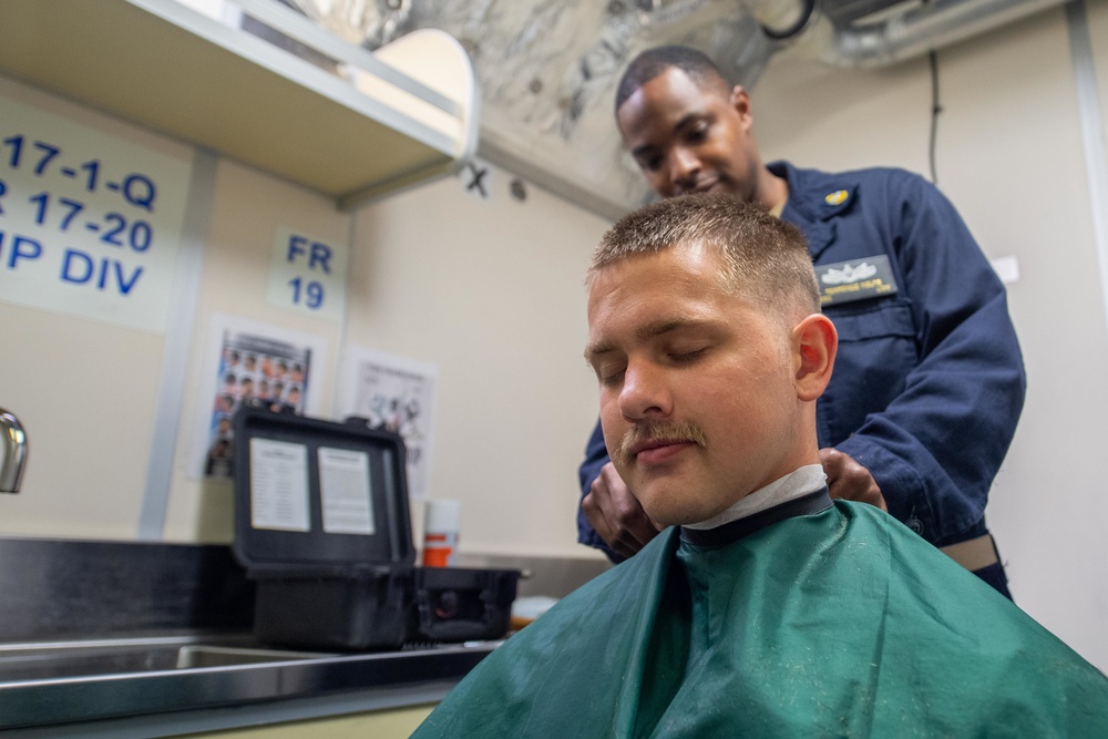 USS Charleston Sailor Receives Haircut