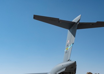 816th Expeditionary Airlift Squadron flies an M1A2 SEPV2 Abrams Tank over Ali Al Salem Air Base