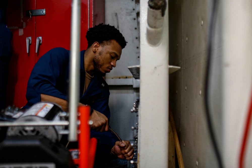 Abraham Lincoln Sailors inspect and clean piping