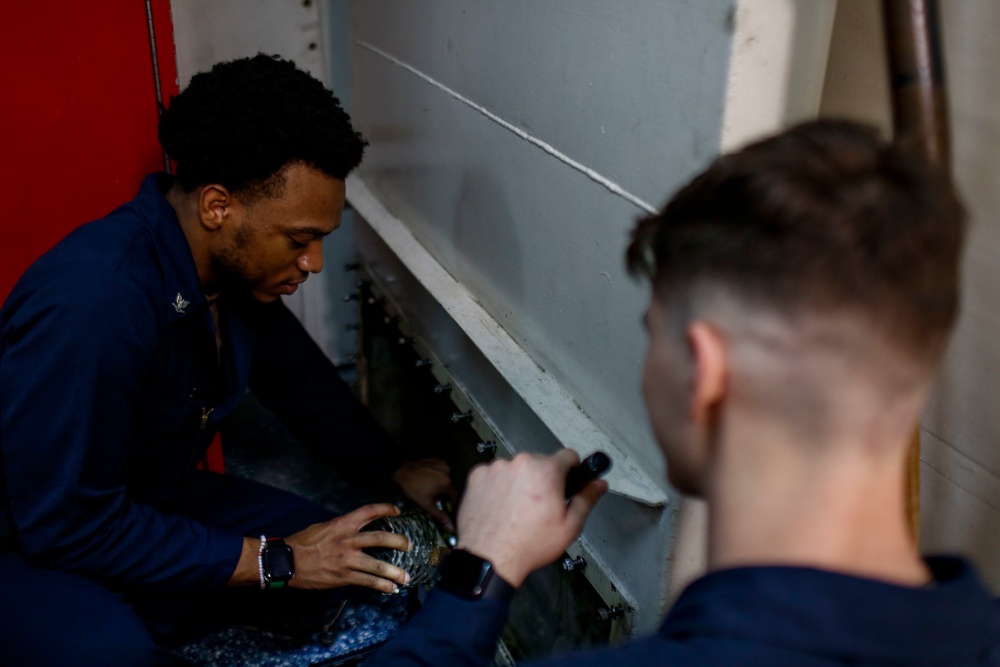 Abraham Lincoln Sailors inspect and clean piping