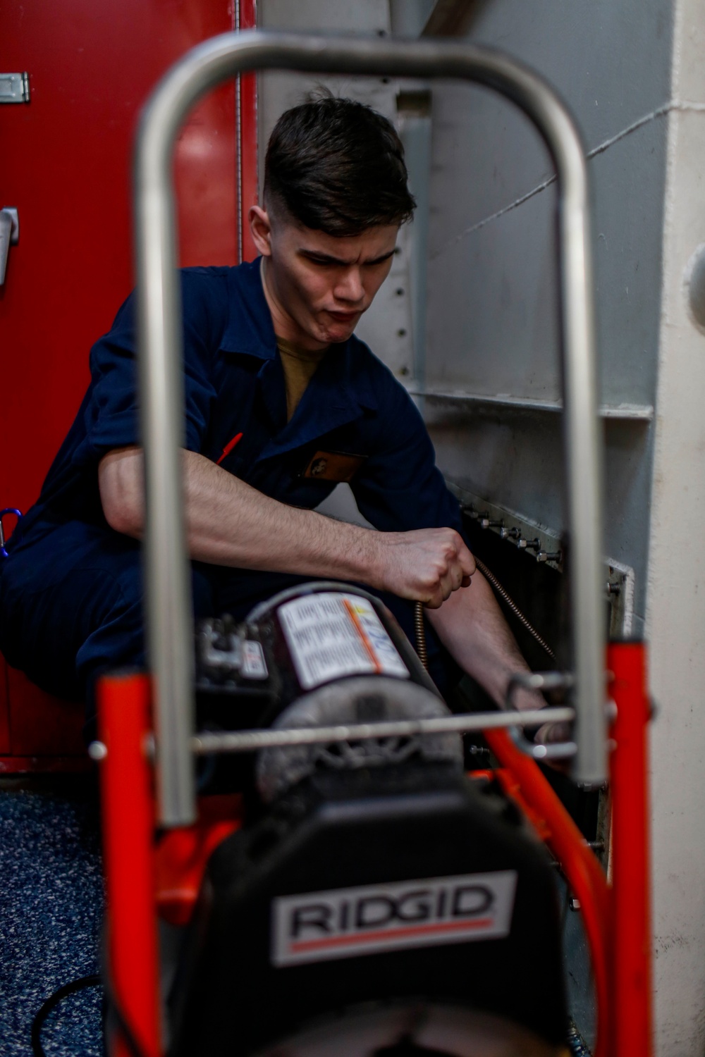 Abraham Lincoln Sailors inspect and clean piping