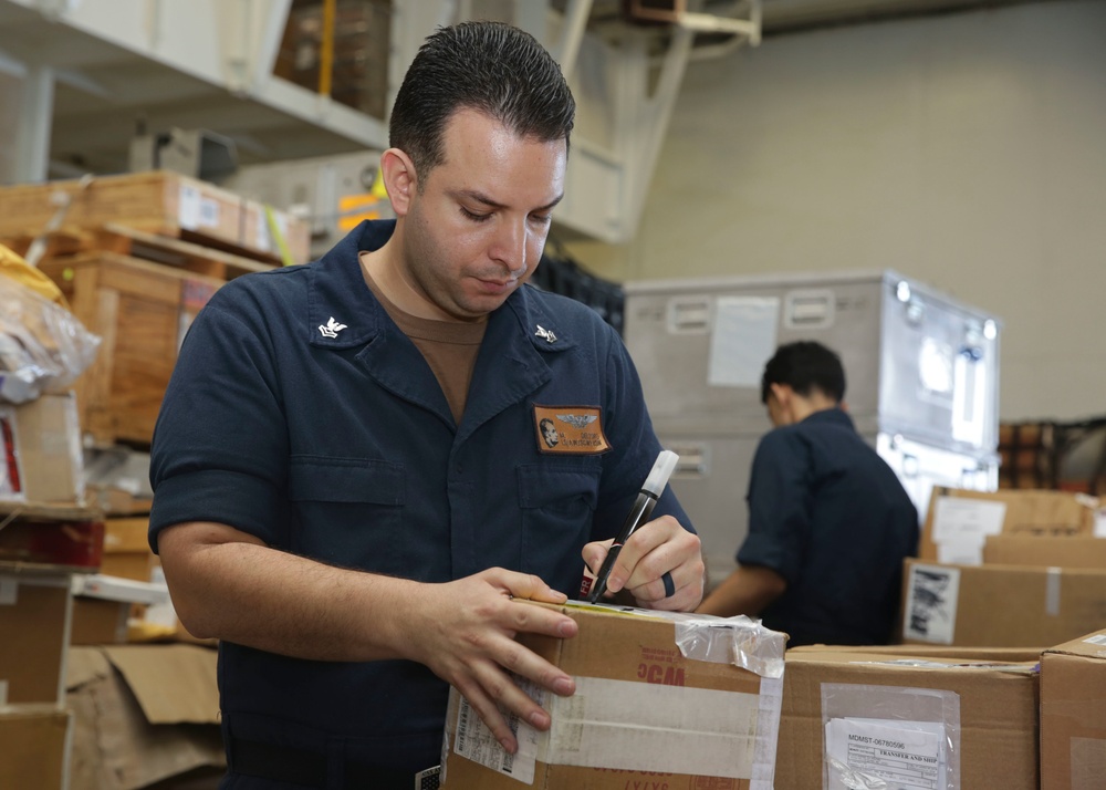 Abraham Lincoln Sailors sort cargo