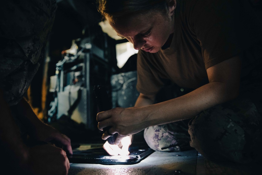 HSC 28 Sailors Install Equipment to Sea Hawk Helicopter