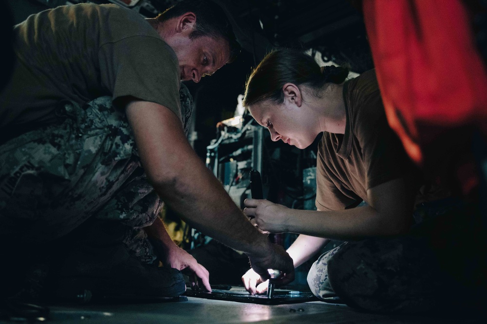 HSC 28 Sailors Install Equipment to Sea Hawk Helicopter