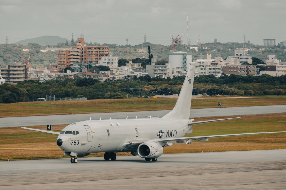 U.S. Marines work with the U.S. Navy on refueling a P-8A Poseidon during Noble Fusion