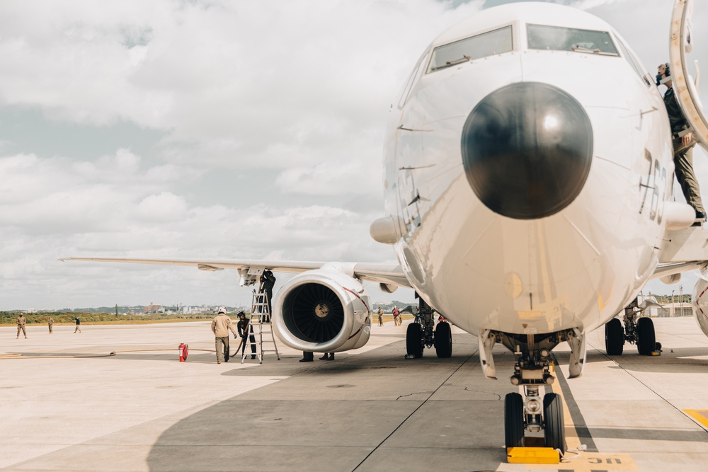 U.S. Marines work with the U.S. Navy on refueling a P-8A Poseidon during Noble Fusion