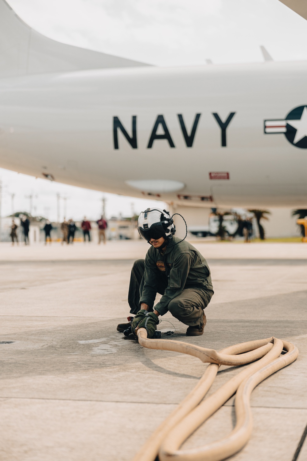 U.S. Marines work with the U.S. Navy on refueling a P-8A Poseidon during Noble Fusion