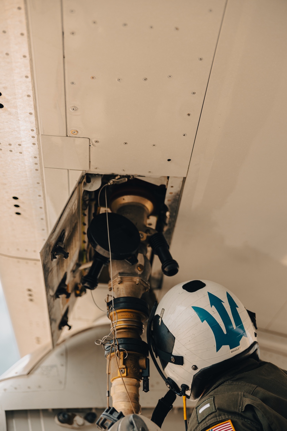 U.S. Marines work with the U.S. Navy on refueling a P-8A Poseidon during Noble Fusion