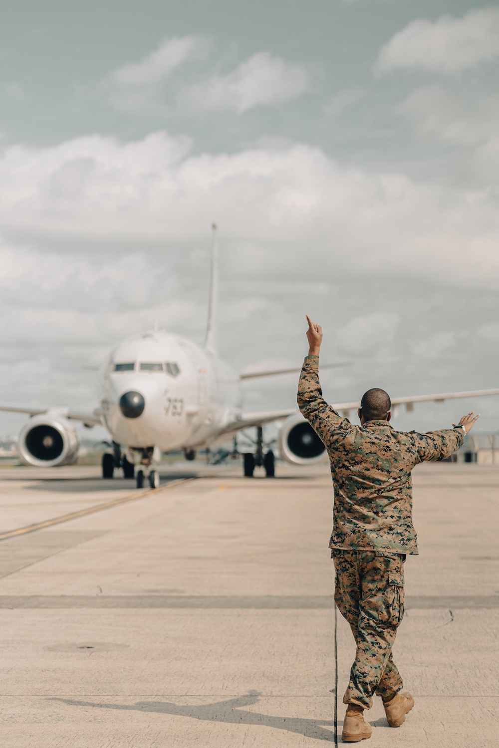 U.S. Marines work with the U.S. Navy on refueling a P-8A Poseidon during Noble Fusion