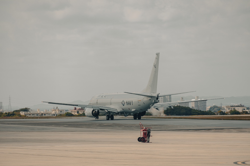 U.S. Marines work with the U.S. Navy on refueling a P-8A Poseidon during Noble Fusion