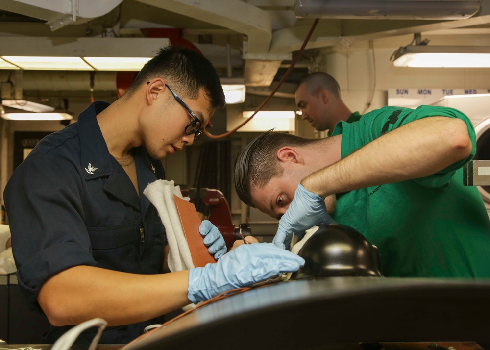 Abraham Lincoln Sailors conduct aircraft maintenance