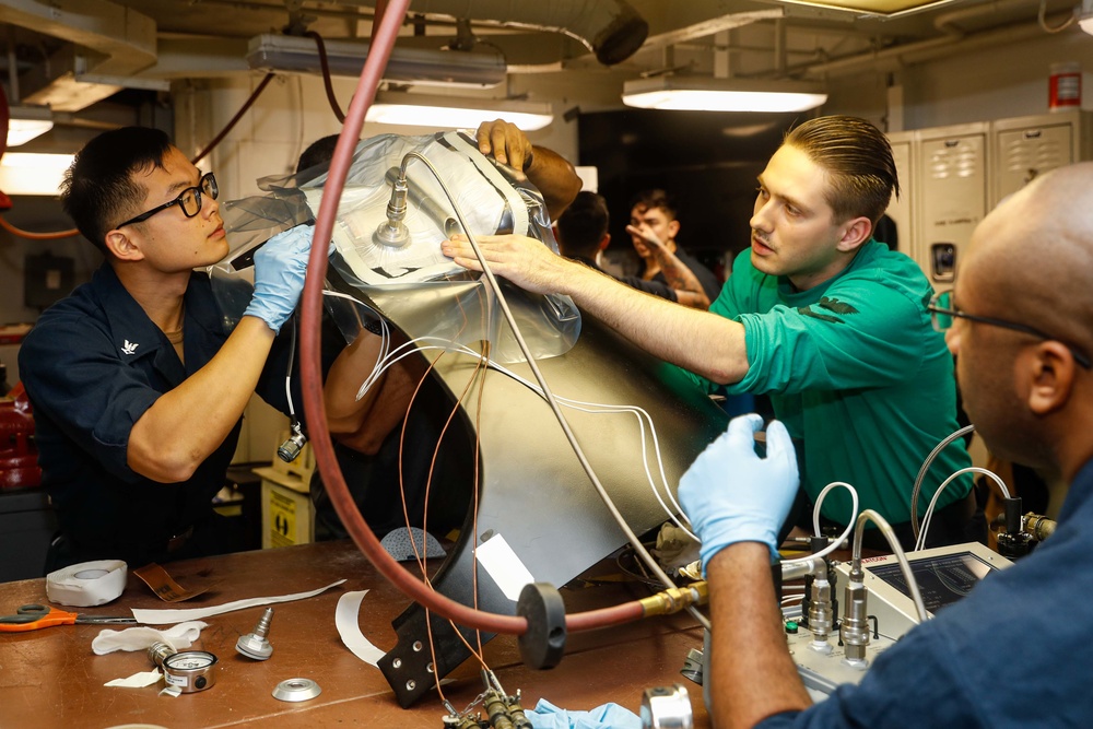 Abraham Lincoln Sailors conduct aircraft maintenance