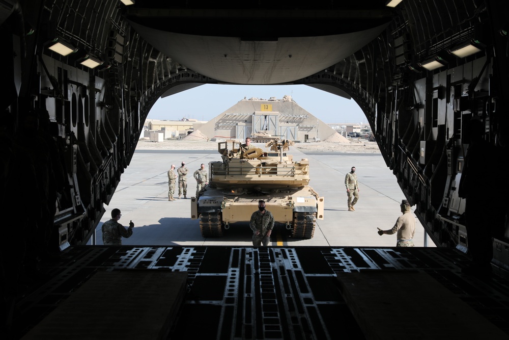 816th Expeditionary Airlift Squadron flies an M1A2 SEPV2 Abrams Tank over Ali Al Salem Air Base