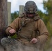 Marine engineers and Navy Seabees construct a one rope bridge during Winter Pioneer 22