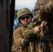 Marine engineers and Navy Seabees construct a one rope bridge during Winter Pioneer 22