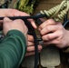 Marine engineers and Navy Seabees construct a one rope bridge during Winter Pioneer 22