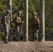 Marine engineers and Navy Seabees construct a one rope bridge during Winter Pioneer 22