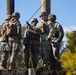 Marine engineers and Navy Seabees construct a one rope bridge during Winter Pioneer 22