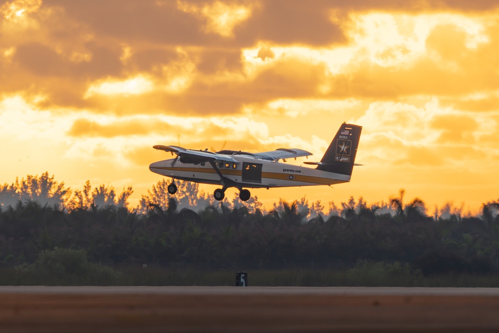 The Army Parachute Team's aircraft takes flight at sunrise