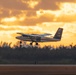 The Army Parachute Team's aircraft takes flight at sunrise