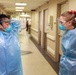 U.S. Air Force nurse and INTEGRIS Health nurse prepare to provide care to a COVID patient