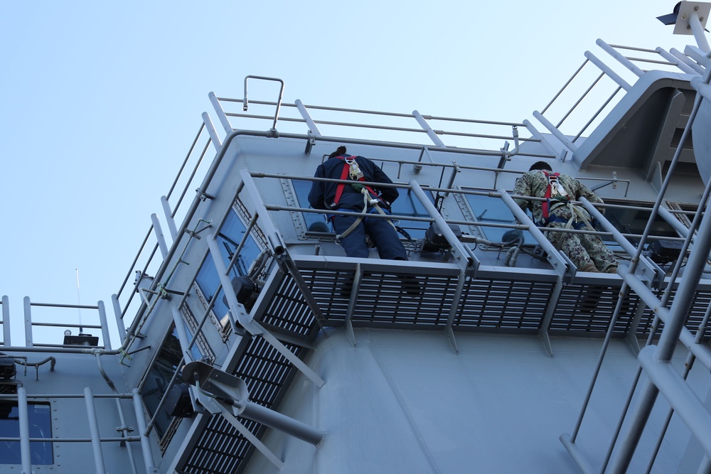 SAN DIEGO (Feb. 9, 2022) Sailors clean windows above