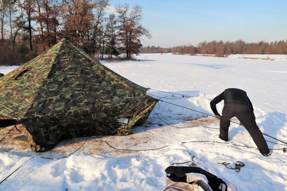 Cold-Weather Operations Course class 22-03 students build Arctic tents on Fort McCoy's South Post