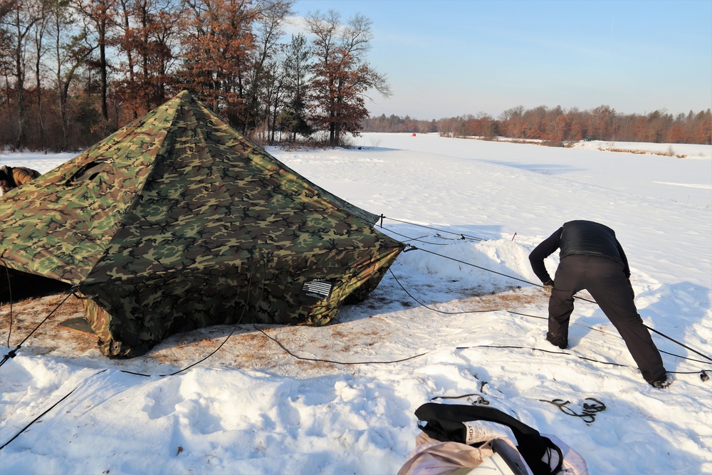 Cold-Weather Operations Course class 22-03 students build Arctic tents on Fort McCoy's South Post