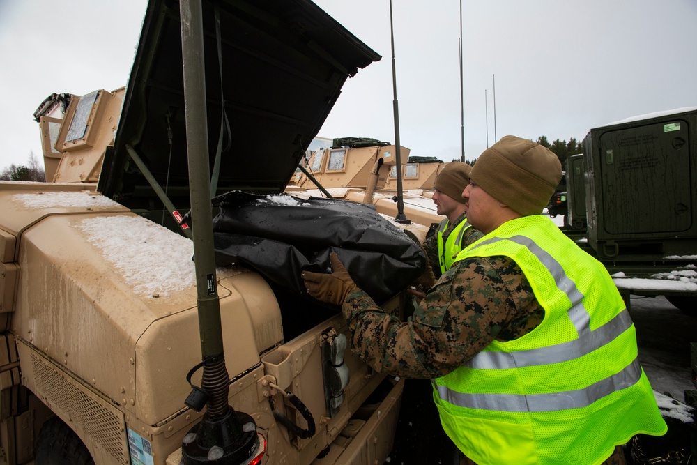 Marines prepare vehicles for a convoy movement prior to Exercise Cold Response 2022