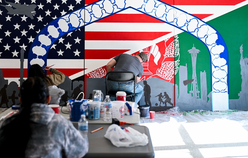 TF-L members and guests paint mural depicting journey
