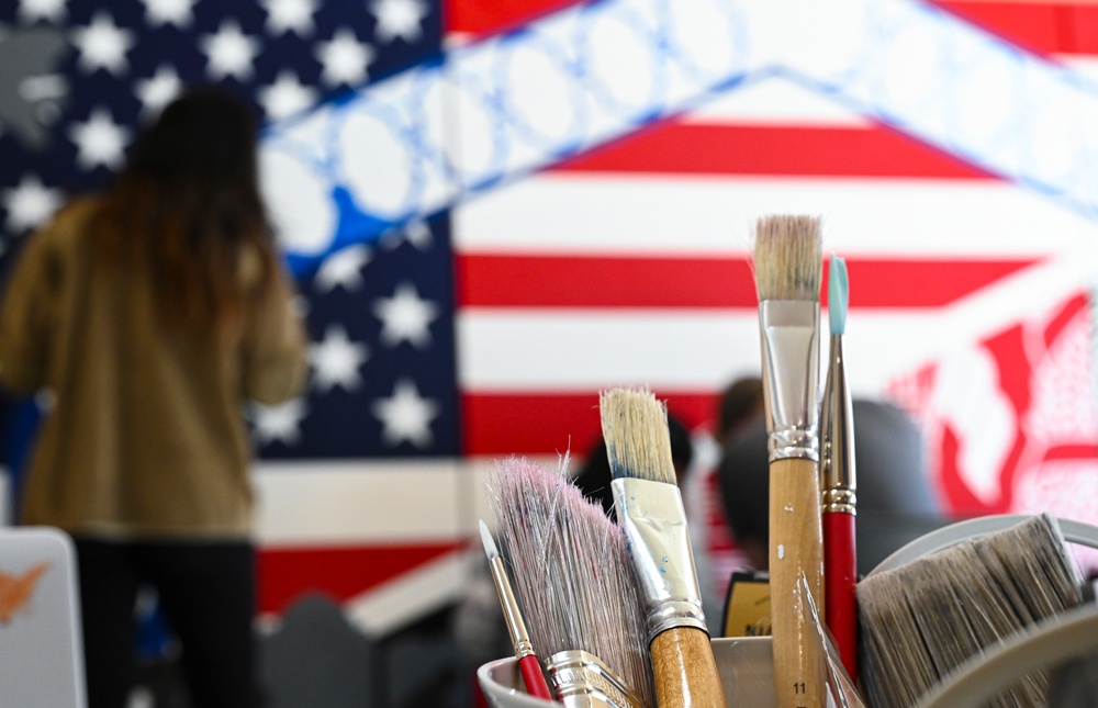 TF-L members and guests paint mural depicting journey