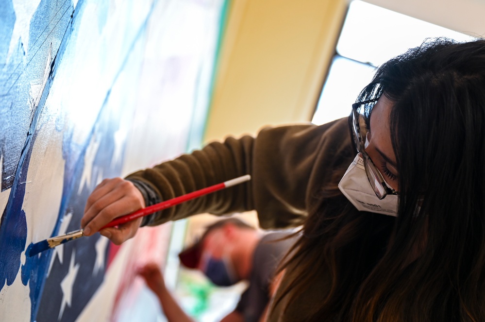 TF-L members and guests paint mural depicting journey