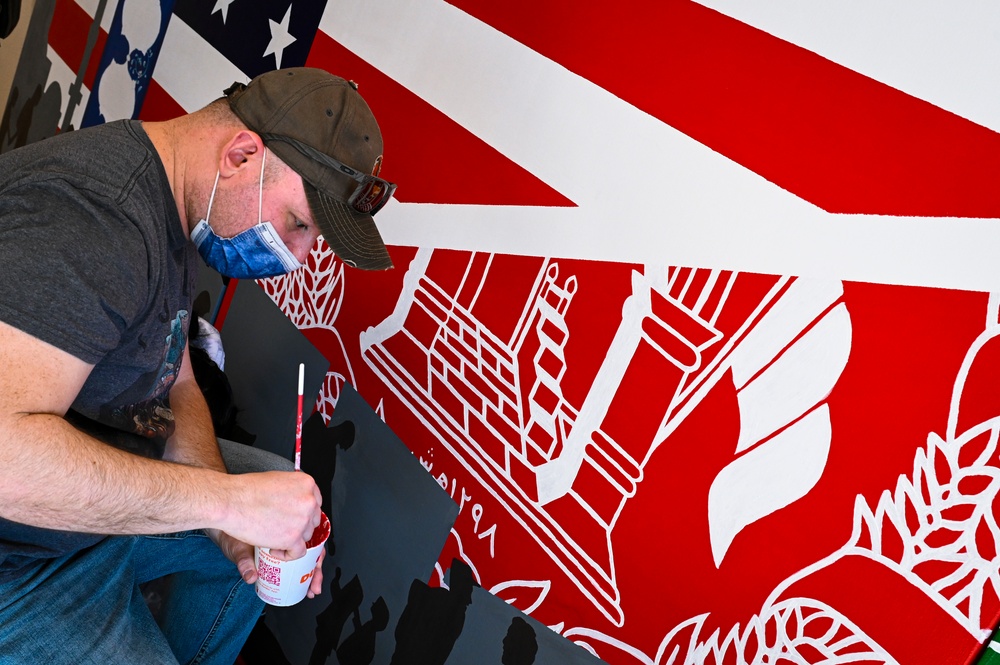 TF-L members and guests paint mural depicting journey