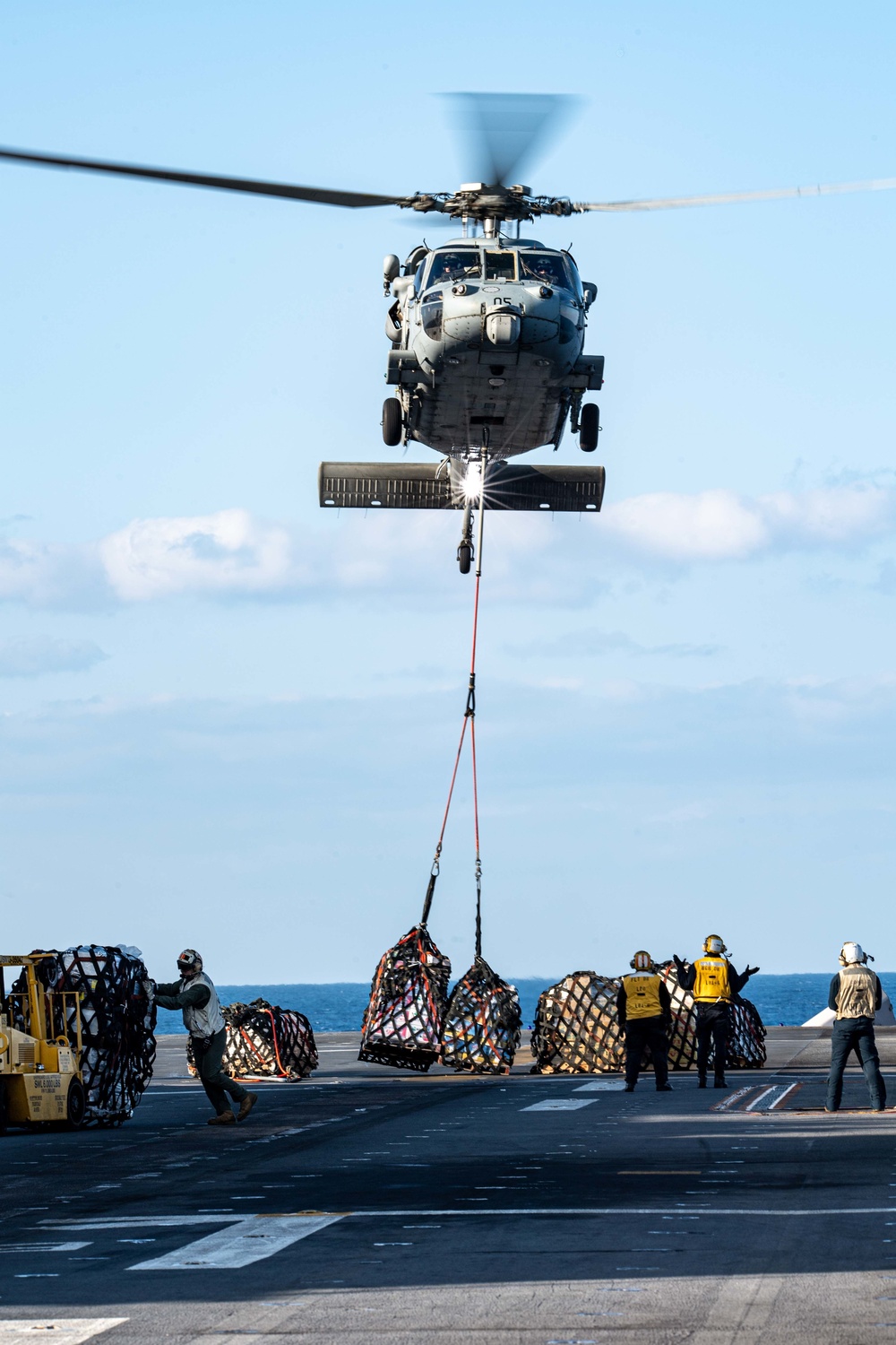 USS America conducts a vertical replenishment with the fleet replenishment oiler USNS Yukon (T-AO 202).