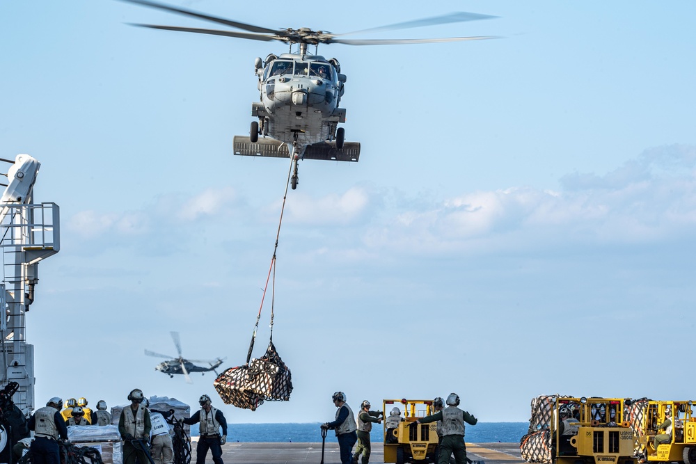 USS America conducts a vertical replenishment with the fleet replenishment oiler USNS Yukon (T-AO 202).